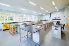 an empty lab with tables and yellow bins