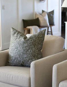 a living room filled with furniture and pillows