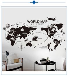 the world map wall decal is shown in black and white with an airplane flying over it