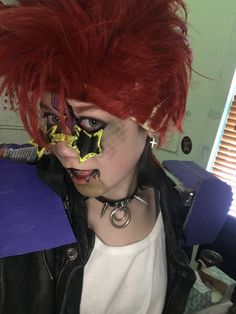 a woman with red hair and piercings on her face