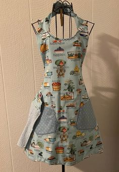 the apron dress is hanging on a rack