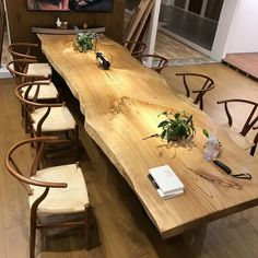 a long wooden table with chairs around it