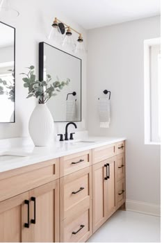 a bathroom with two sinks and a large mirror