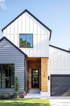 a modern house with two garages on the front and one door open to let in lots of light