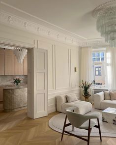 a living room filled with furniture and a chandelier