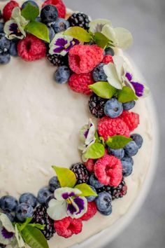 a cake decorated with fresh berries and blueberries