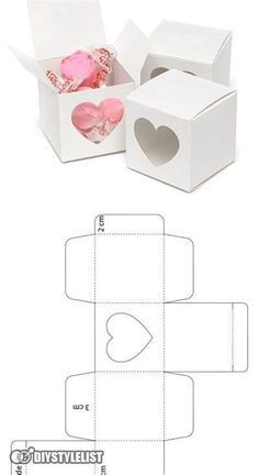 an open box with two hearts inside and one in the middle, cut out from paper