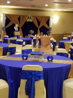 a banquet room set up with blue and gold decorations