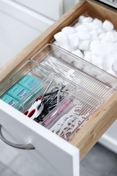 an organized drawer with scissors and other items