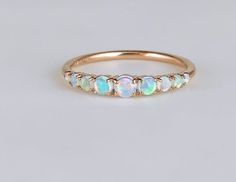 Vintage Opal ring,Natural Opal band, Opal Wedding Band, Rose Gold Opal Ring, Dainty Opal Ring, October Birthstone Ring, Matching Band Ring *Item Description* Metal Purity: 925 parts per 1000 Gemstone: Ethiopian Opal Color : White Stone shape _ round Stone size _ 2.mm, 3.mm, 4.mm Clarity: Eye Clean Finishing:- Super Fine Band Color:- Silver/Gold/Rose Gold Occasion: commitment style: Ring Size: We make rings from US 4 to US 10. Ring Size: We make rings from US 4 to US 10. (If you need smaller or bigger ring size, please ask me to resize) Country of Manufacture: India All our work is custom made by hand with Love and Care in our workshop ♥ CUSTOM ORDERS Please let us know if you want any customization or personalization in this ring or you want a custom ring of size and shape we will craft an Delicate Opal Ring, Opal Ring Simple, Dainty Opal Ring, Vintage Opal Ring, Opal Band Ring, Gold Opal Ring, Opal Wedding Band, Opal Ring Vintage, October Birthstone Ring