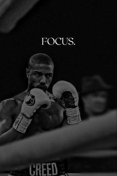 a black and white photo of a man in boxing gloves with the words focus on it