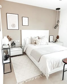 a white bed sitting in a bedroom on top of a floor next to a window