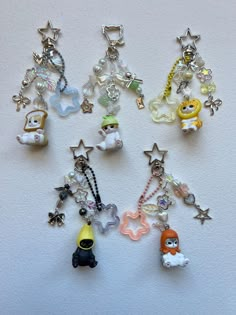 a collection of key chains with charms attached to them