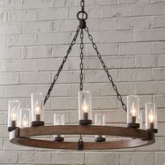 a wooden chandelier with glass jars hanging from it