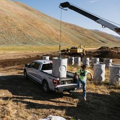 a truck is being lifted by a crane