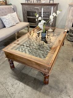 a coffee table with glass top and wooden legs