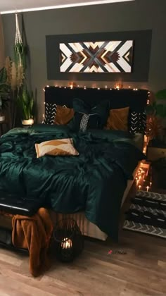 a bed with green comforter and pillows in a room decorated with plants, lights and rugs