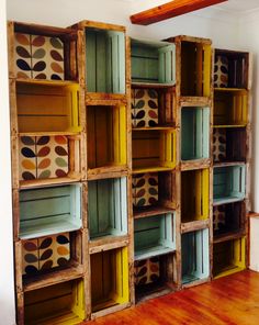 several wooden crates are stacked on top of each other in a room with wood floors