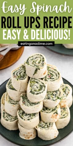 spinach rolls stacked on top of each other with text overlay that reads easy spinach roll ups recipe easy and delicious