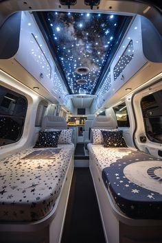 the interior of an airplane with two beds and stars painted on the ceiling above them