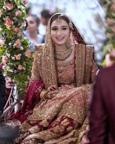 a woman in a wedding outfit sitting down