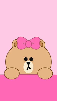 a brown teddy bear with a pink bow on its head