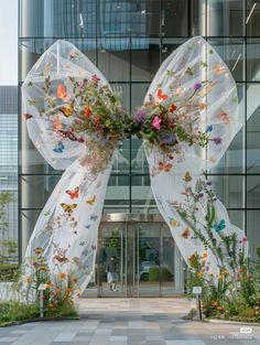 an entrance to a building decorated with flowers and butterflies