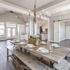 the dining room table is set with white plates and place settings for four people to eat