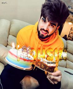 a man sitting on a couch holding a cake