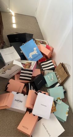 a pile of paper bags sitting on top of a carpeted floor next to a white wall