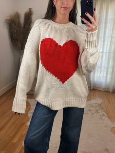 Adorable Oversized Off White Loose Knit Sweater ft. Big Red Heart Detail on Front. A great year round sweater but so adorable for Valentines day! Maclaine is 5'7 wearing a size SMALL. Model is 5’4 wearing a size LARGE. This has a naturally oversized fit! Cute Fall Cable Knit Sweater, Cute Cable Knit Fall Sweater, Cute Cable Knit Sweater For Fall, White Heart Sweater For Winter, Cute Winter Sweater With Heart Print, Cute Oversized Chunky Knit Sweater, Cute Chunky Knit Sweater For Fall, Cute Heart Print Winter Sweater, Cute Soft Knit Acrylic Sweater