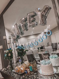 a table topped with lots of cake and balloons in front of a mirror filled with confetti