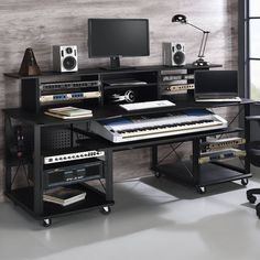 a black computer desk topped with lots of musical equipment