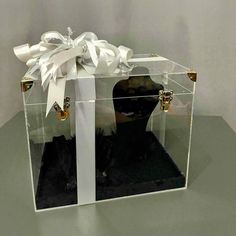 a clear box with a white bow on it