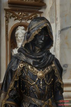 a statue of a woman in black and gold with a white busturine behind her