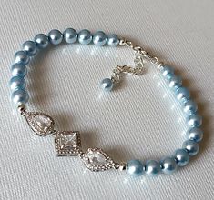 Blush Blue Light Blue Pearl Cubic Zirconia Silver One Strand Classic Wedding Bridal Bracelet. PLEASE READ ITEM DESCRIPTION and SHOP POLICIES before placing your order, and contact me with any questions! BRACELET is about 7.40 inches (18.8cm) long plus 1 inch extender chain. LIGHT BLUE PEARL JEWELRY: https://www.etsy.com/shop/LanaChayka?ref=seller-platform-mcnav&search_query=light+blue+pearls BRIDAL EARRINGS SECTION: https://www.etsy.com/shop/LanaChayka?ref=seller-platform-mcnav§ion_id=11638940 BRIDAL JEWELRY SETS SECTION: https://www.etsy.com/shop/LanaChayka?ref=seller-platform-mcnav§ion_id=25839214 BRIDAL NECKLACES SECTION: https://www.etsy.com/shop/LanaChayka?ref=seller-platform-mcnav§ion_id=11638944 Elegant and timeless, this gorgeous bracelet is perfect for weddings or special occasion Blue Pearl Jewelry, Blue Pearl Bracelet, Bridal Bracelets, Blue Wedding Jewelry, Pearl Bracelet Wedding, Wedding Blush, Blue Pearls, Wedding Bracelets, Bracelet Wedding