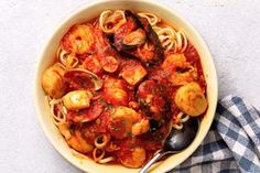 a bowl of pasta with shrimp and tomato sauce