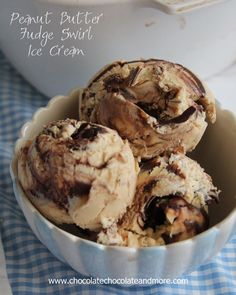 three scoops of ice cream in a bowl on a blue and white checkered tablecloth