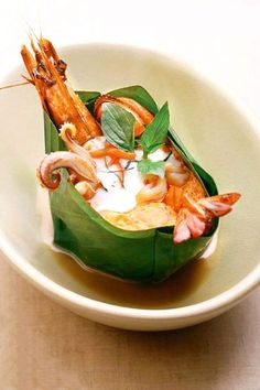 a white bowl filled with food on top of a table