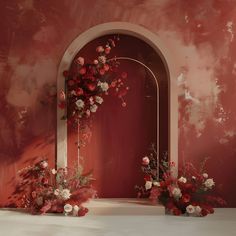 red and white flowers are in vases on the floor next to an arch that is painted pink