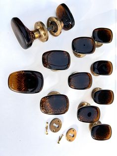 a group of brown and black knobs sitting on top of a white table