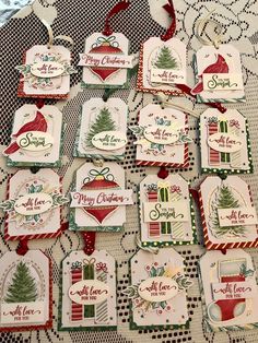 some christmas tags are hanging on a table