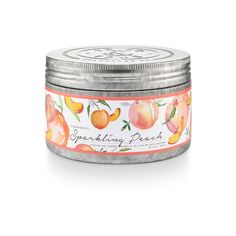 an orange and peach scented candle in a tin