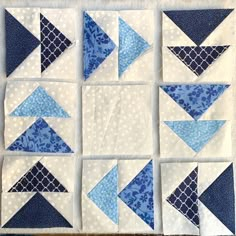 the blocks have blue and white quilts on each side, along with an arrow in the middle