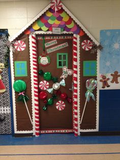 a door decorated to look like a gingerbread house with candy and candies on it