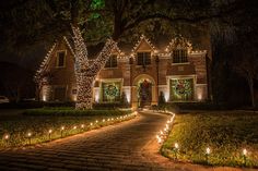 a house is lit up with christmas lights