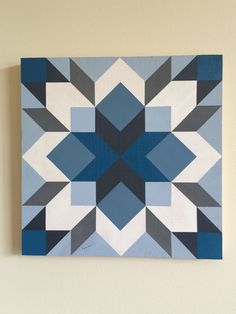 a blue and white painting hanging on the wall