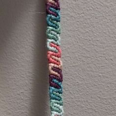 a crocheted toothbrush holder hanging on a wall