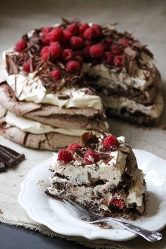 there is a piece of cake with raspberries on it and a fork next to it