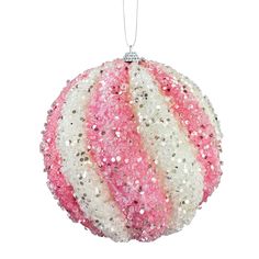 a pink and white ball ornament hanging from a string on a white background